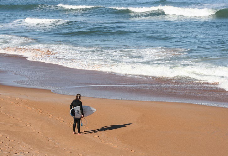 Echo Photo exhibition. Photo looking at surfer checking waves standing back to camera.