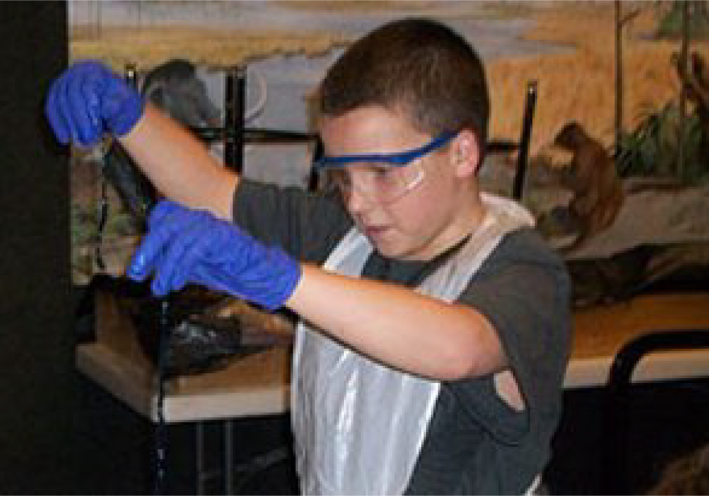 Asset 81@4x Child in museum doing experiment/learning.
